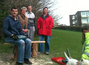 some of the members who came to help resting on/around the bench when it was finished